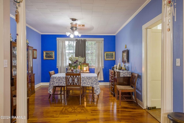 dining area featuring ornamental molding, dark hardwood / wood-style floors, and ceiling fan