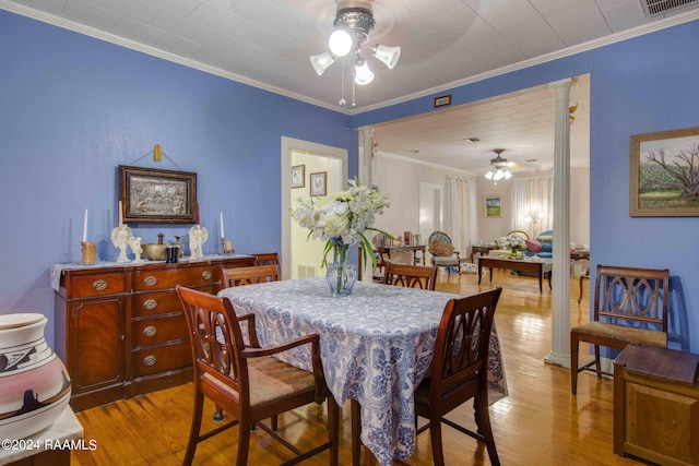 dining area featuring ceiling fan, ornamental molding, decorative columns, and light hardwood / wood-style flooring