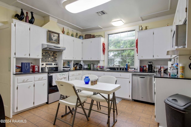 kitchen featuring white cabinetry, crown molding, and appliances with stainless steel finishes