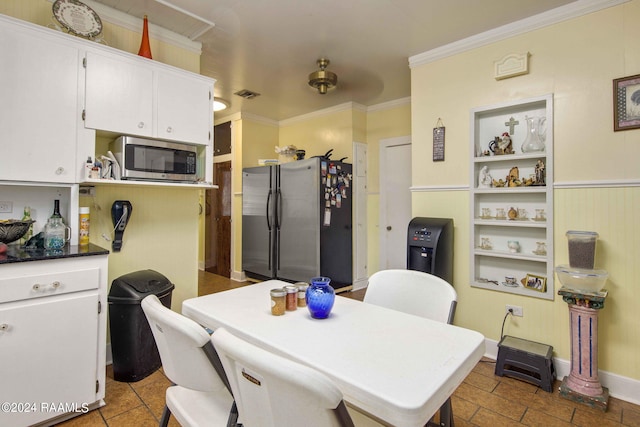 dining room featuring crown molding