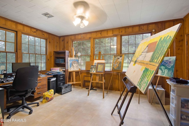 office area featuring crown molding and wood walls