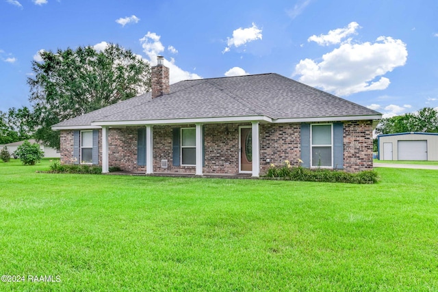 ranch-style home with covered porch, a front lawn, and a garage