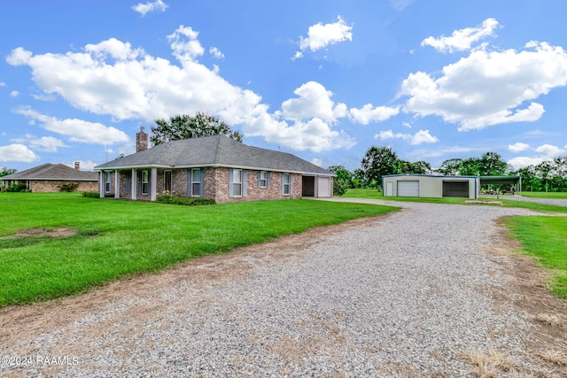 single story home featuring a carport, a garage, and a front yard