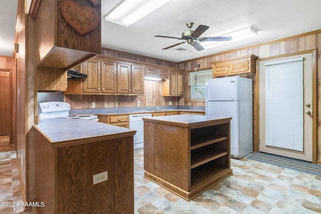 kitchen with sink, white appliances, ceiling fan, extractor fan, and a kitchen island