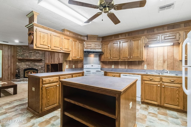 kitchen featuring sink, a kitchen island, white appliances, and ceiling fan