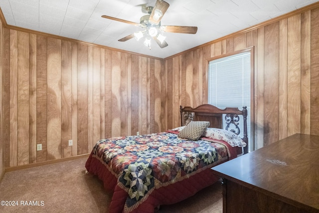 carpeted bedroom with ceiling fan and ornamental molding