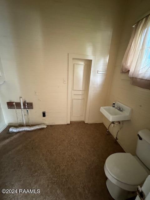 bathroom featuring sink, tile patterned flooring, and toilet