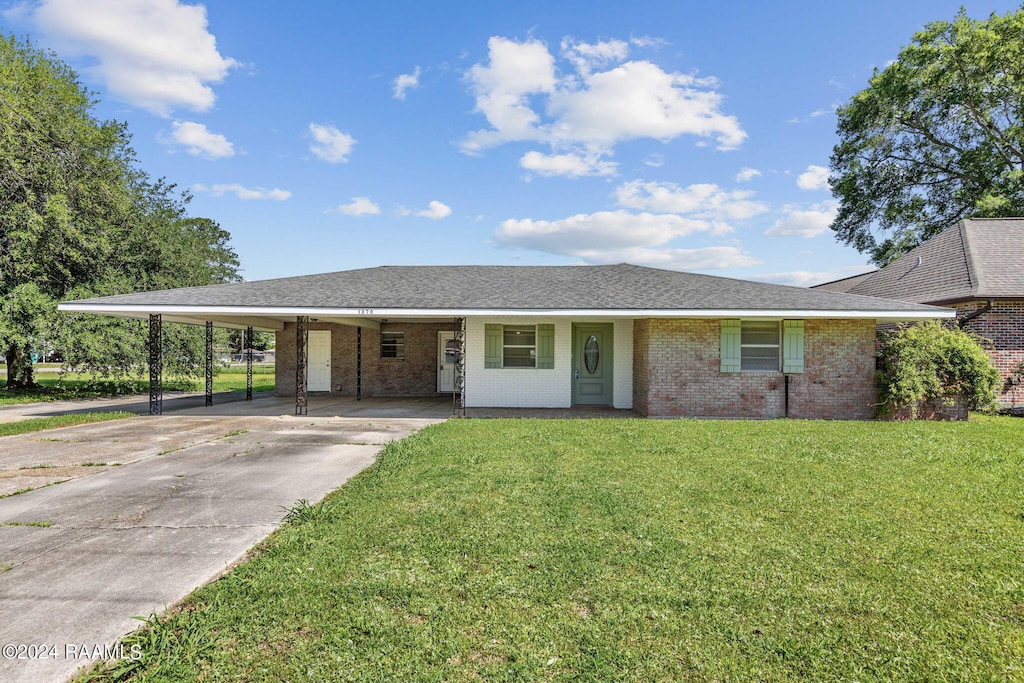 ranch-style house with a carport and a front yard