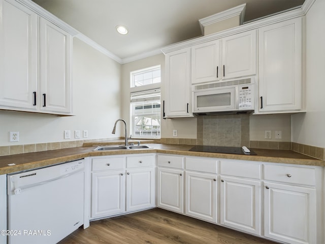 kitchen featuring a sink, white appliances, ornamental molding, and white cabinets