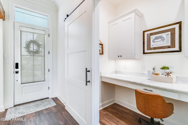 entryway featuring built in desk, a barn door, and dark hardwood / wood-style floors