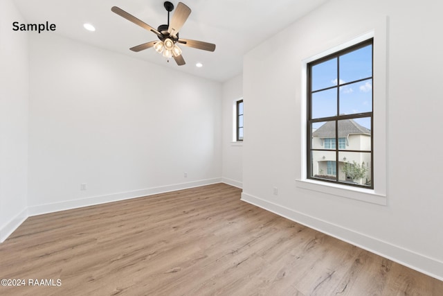 empty room featuring light wood-type flooring and ceiling fan