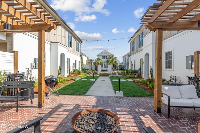 view of patio featuring a fire pit and a pergola