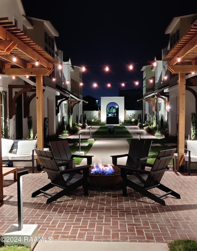 patio at twilight featuring a pergola