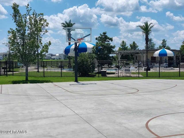 view of basketball court featuring a yard