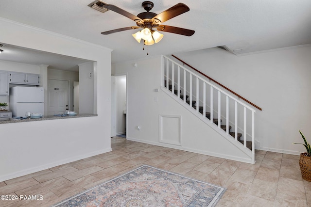 unfurnished living room featuring stairway, a ceiling fan, baseboards, and ornamental molding