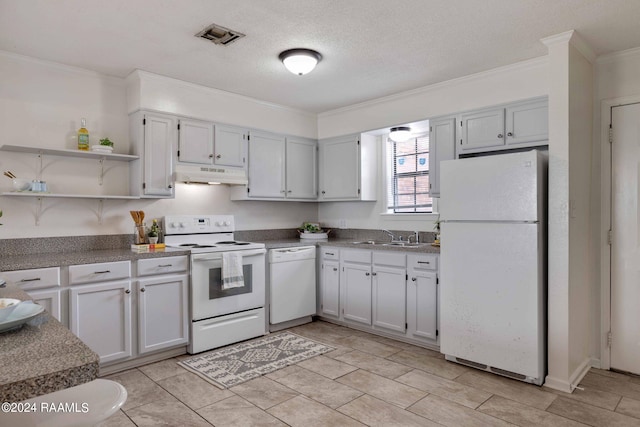 kitchen featuring visible vents, under cabinet range hood, ornamental molding, white appliances, and a sink