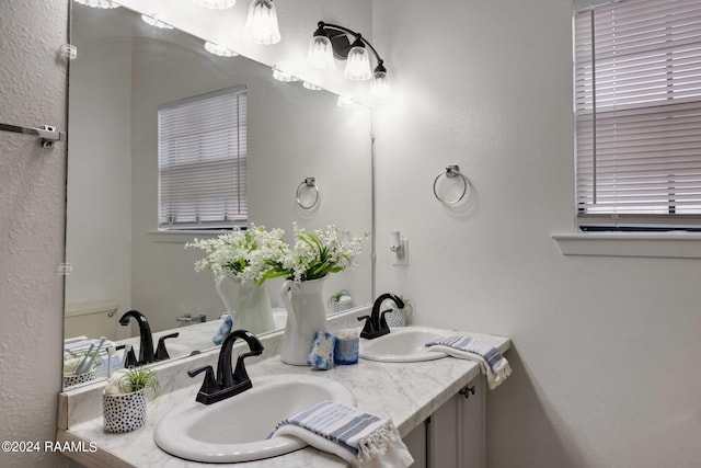 bathroom featuring double vanity and a sink