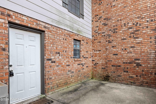 entrance to property with brick siding