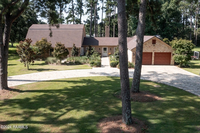 new england style home with a garage and a front lawn