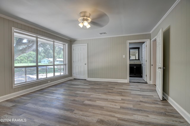 spare room with ceiling fan, hardwood / wood-style floors, and ornamental molding