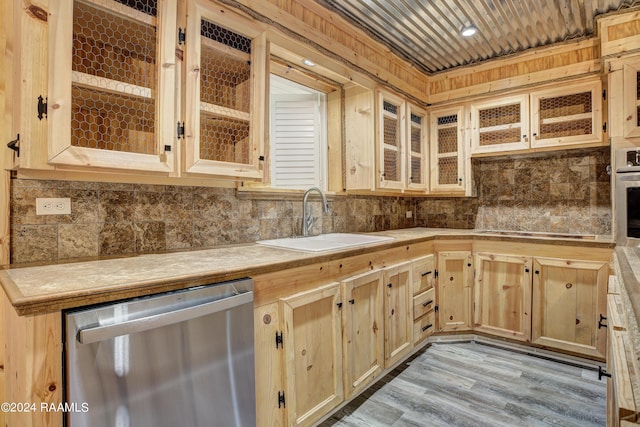 kitchen featuring light brown cabinetry, light wood-type flooring, appliances with stainless steel finishes, and sink