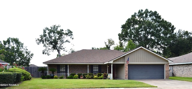 ranch-style house with covered porch, a garage, and a front lawn