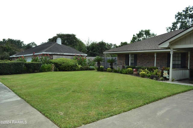 view of yard featuring covered porch