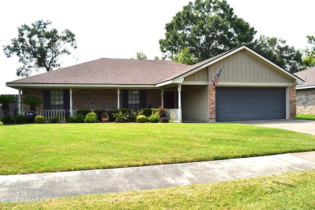 single story home with a garage, a front yard, and a porch