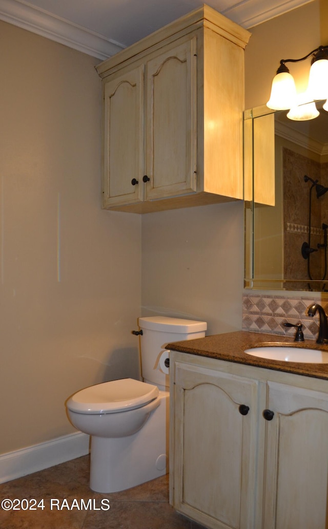 bathroom with crown molding, vanity, toilet, and tile patterned floors