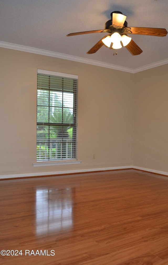 spare room featuring ornamental molding, hardwood / wood-style floors, and ceiling fan