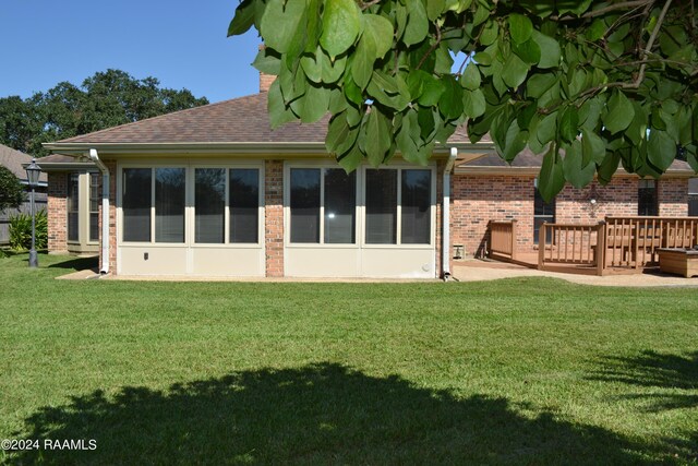 back of property featuring a yard and a patio