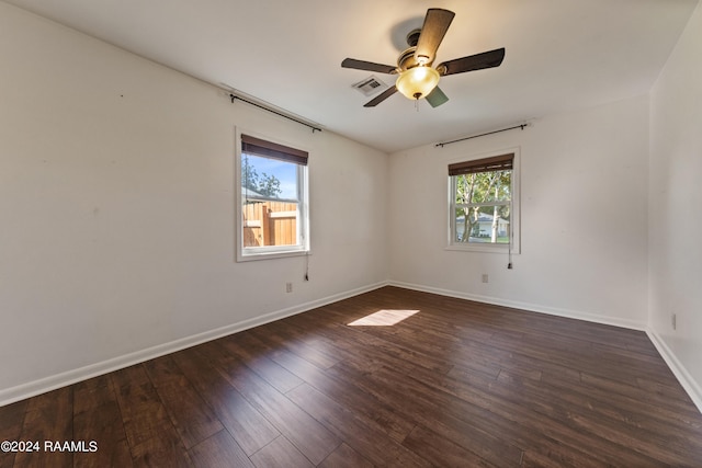 empty room featuring ceiling fan and dark wood-type flooring