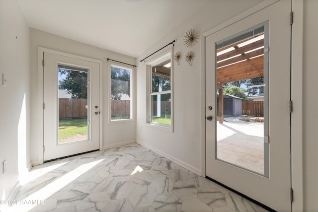 doorway to outside with light tile patterned floors