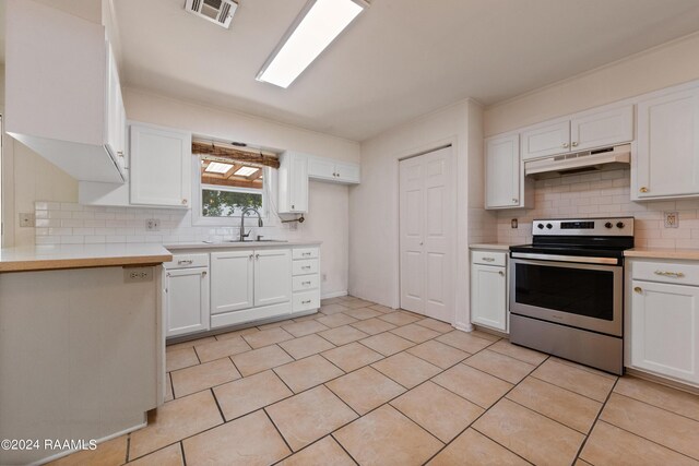 kitchen with sink, stainless steel electric stove, white cabinetry, and light tile patterned floors