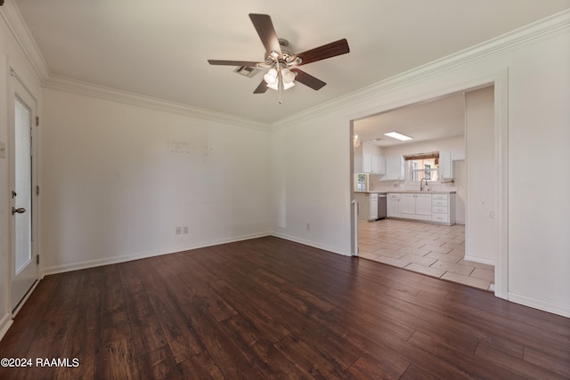 tiled empty room with ceiling fan, sink, and ornamental molding