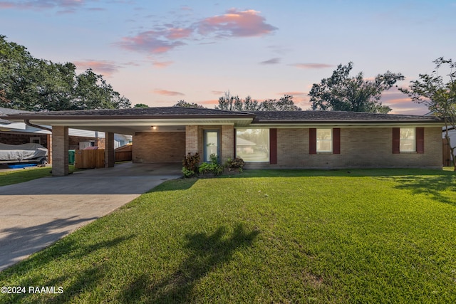 view of front facade with a carport and a lawn