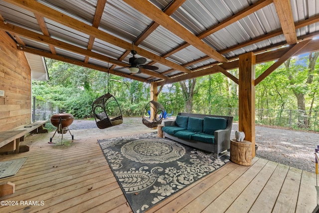 deck featuring ceiling fan and an outdoor living space