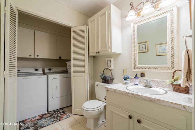 bathroom with separate washer and dryer, vanity, toilet, tile patterned floors, and a textured ceiling