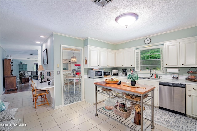 kitchen with ornamental molding, appliances with stainless steel finishes, sink, and white cabinets