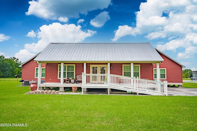 rear view of property with a lawn and covered porch