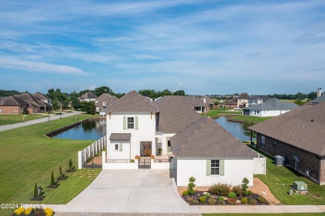 view of front facade with central AC unit, a front yard, and a water view