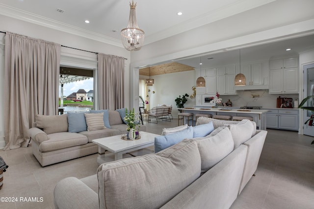 living room featuring crown molding and a notable chandelier