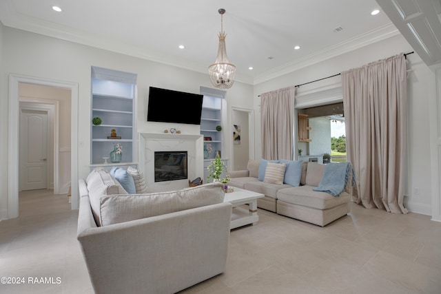 living room with ornamental molding, a high end fireplace, a chandelier, and built in features