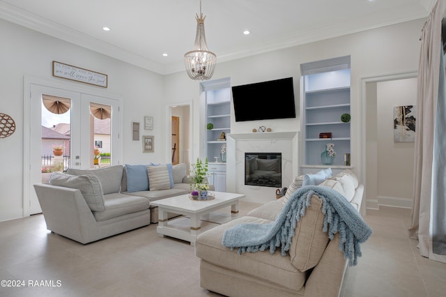 living room featuring built in shelves, a fireplace, ornamental molding, and french doors