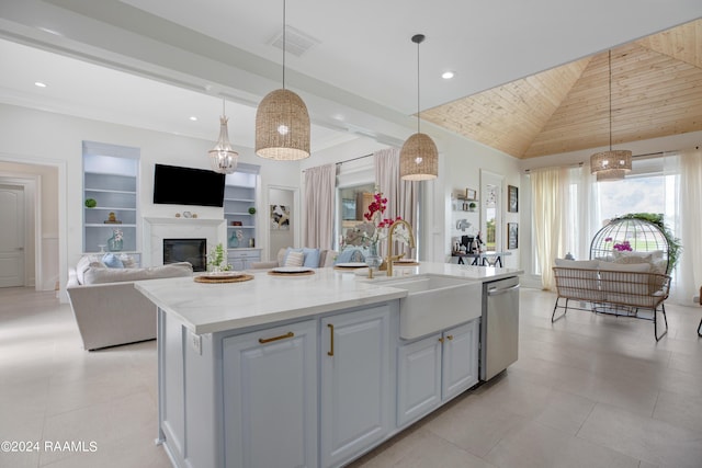 kitchen with built in features, dishwasher, sink, hanging light fixtures, and a kitchen island with sink