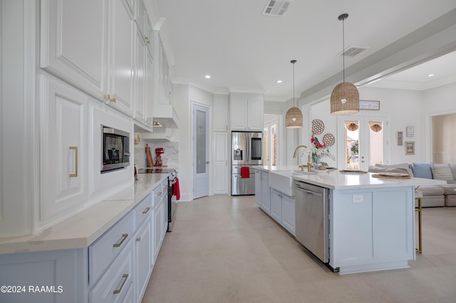 kitchen with stainless steel appliances, sink, pendant lighting, and white cabinets