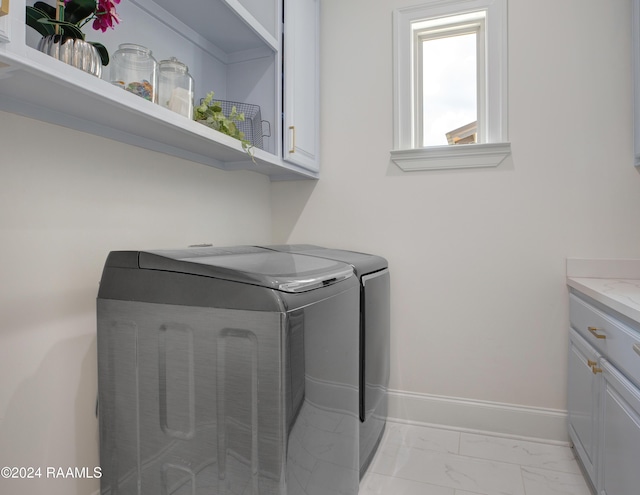 laundry room featuring cabinets and washing machine and clothes dryer