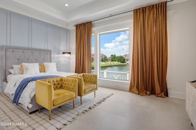 bedroom featuring a water view and light tile patterned floors