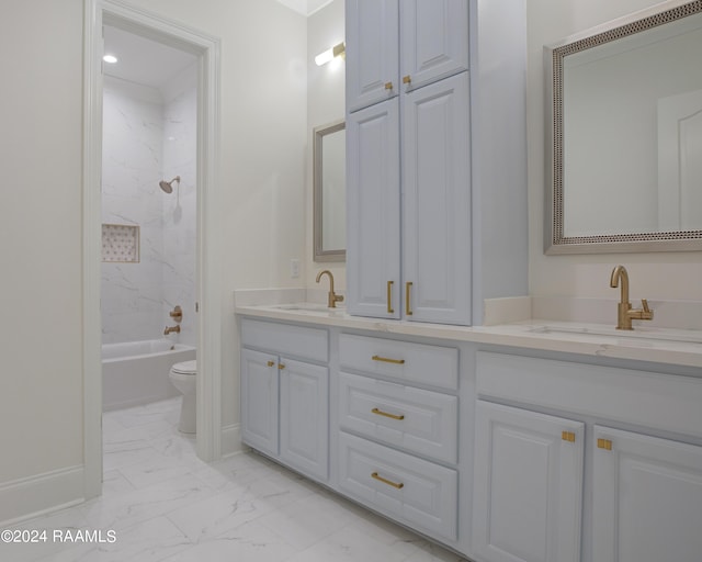 full bathroom with tiled shower / bath, vanity, and toilet