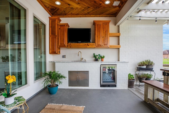 bar featuring brick wall, sink, and wooden ceiling